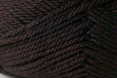 Close-up image of dark brown yarn. The Jo Sharp Classic DK Wool by Kingfisher Yarn & Fibre is tightly wound, with visible texture and intricate patterns of the fibers. The overall color appears rich and slightly variegated with hints of darker and lighter brown tones, showcasing its versatile DK gauge in premium grade wool.