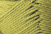 Close-up image of yellow yarn wound tightly, showing the detailed twisted texture of the fibers. The Kingfisher Yarn & Fibre Jo Sharp Classic DK Wool appears soft and thick, with a slightly fuzzy surface. The strands run diagonally across the image, creating a visually appealing pattern.