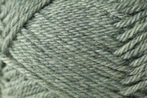 Close-up view of a ball of Jo Sharp Classic DK Wool yarn from Kingfisher Yarn & Fibre, featuring tightly wrapped strands with a slight sheen. The soft, green texture and weaving pattern are visible, highlighting the intricate details of this versatile DK gauge yarn. Ideal for knitting, crocheting, or crafting projects.