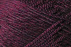 Close-up image of dark maroon Jo Sharp Classic DK Wool fibers from Kingfisher Yarn & Fibre, wound together in a neat, textured pattern. The strands of this versatile yarn appear soft and dense, with slight variations in color intensity throughout the premium-grade wool.