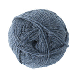 A ball of blue-grey Jo Sharp Classic DK Wool from Kingfisher Yarn & Fibre is neatly wound in a spherical shape, its premium grade yarn visibly soft and thick. Perfect for textured stitches, the yarn is ready for use in knitting or crochet projects.