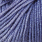 Close-up image of a ball of lavender-colored Jo Sharp Mulberry Silk Georgette Yarn from Kingfisher Yarn & Fibre, with tightly wound strands. The texture of the yarn is clearly visible, showcasing a soft and slightly shiny appearance, reminiscent of heirloom items crafted with Extrafine Merino Wool.