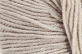 Close-up image of Jo Sharp Mulberry Silk Georgette Yarn by Kingfisher Yarn & Fibre tightly wound in a skein, showcasing the texture and fibers. The beige strands are uniformly twisted and appear soft, suitable for knitting or crochet projects, perfect for creating heirloom items.