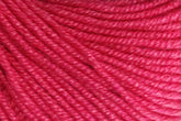 Close-up image of Jo Sharp Mulberry Silk Georgette Yarn by Kingfisher Yarn & Fibre, showing its tightly twisted strands and smooth texture. Made from extrafine Merino wool, the bright pink yarn is evenly colored and appears soft, suitable for knitting or crocheting heirloom items. The detailed texture of the fibers is clearly visible.