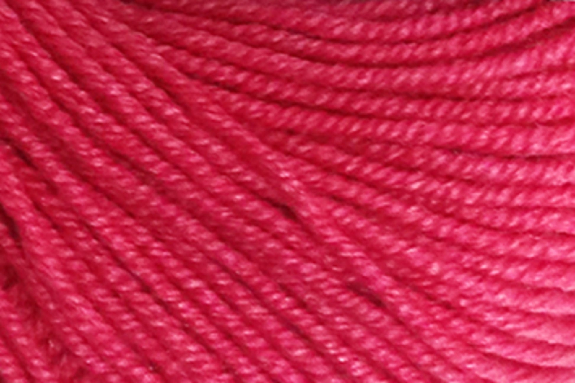 Close-up image of Jo Sharp Mulberry Silk Georgette Yarn by Kingfisher Yarn & Fibre, showing its tightly twisted strands and smooth texture. Made from extrafine Merino wool, the bright pink yarn is evenly colored and appears soft, suitable for knitting or crocheting heirloom items. The detailed texture of the fibers is clearly visible.