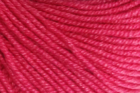 Close-up image of Jo Sharp Mulberry Silk Georgette Yarn by Kingfisher Yarn & Fibre, showing its tightly twisted strands and smooth texture. Made from extrafine Merino wool, the bright pink yarn is evenly colored and appears soft, suitable for knitting or crocheting heirloom items. The detailed texture of the fibers is clearly visible.