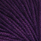 Close-up view of deep purple yarn. The fibers are tightly wound in a consistent spiral pattern, creating a soft, textured surface. Crafted from Jo Sharp Mulberry Silk Georgette by Kingfisher Yarn & Fibre, the rich and dark purple color gives the yarn a luxurious appearance, perfect for heirloom items.