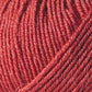 Close-up of a ball of Jo Sharp Mulberry Silk Georgette Yarn by Kingfisher Yarn & Fibre. The texture is detailed and the yarn is tightly wound, showcasing the fine fibers and consistent weave. The color appears to be rich and vibrant, with slight variations in the shade—perfect for crafting heirloom items.