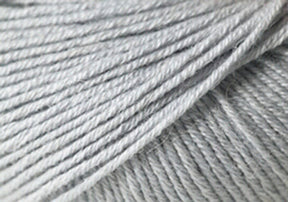 Close-up image of light grey Jo Sharp Mulberry Silk Georgette Yarn from Kingfisher Yarn & Fibre. The fibers are tightly spun and smooth, showcasing the texture and evenness of the threads, reminiscent of heirloom items crafted with care.