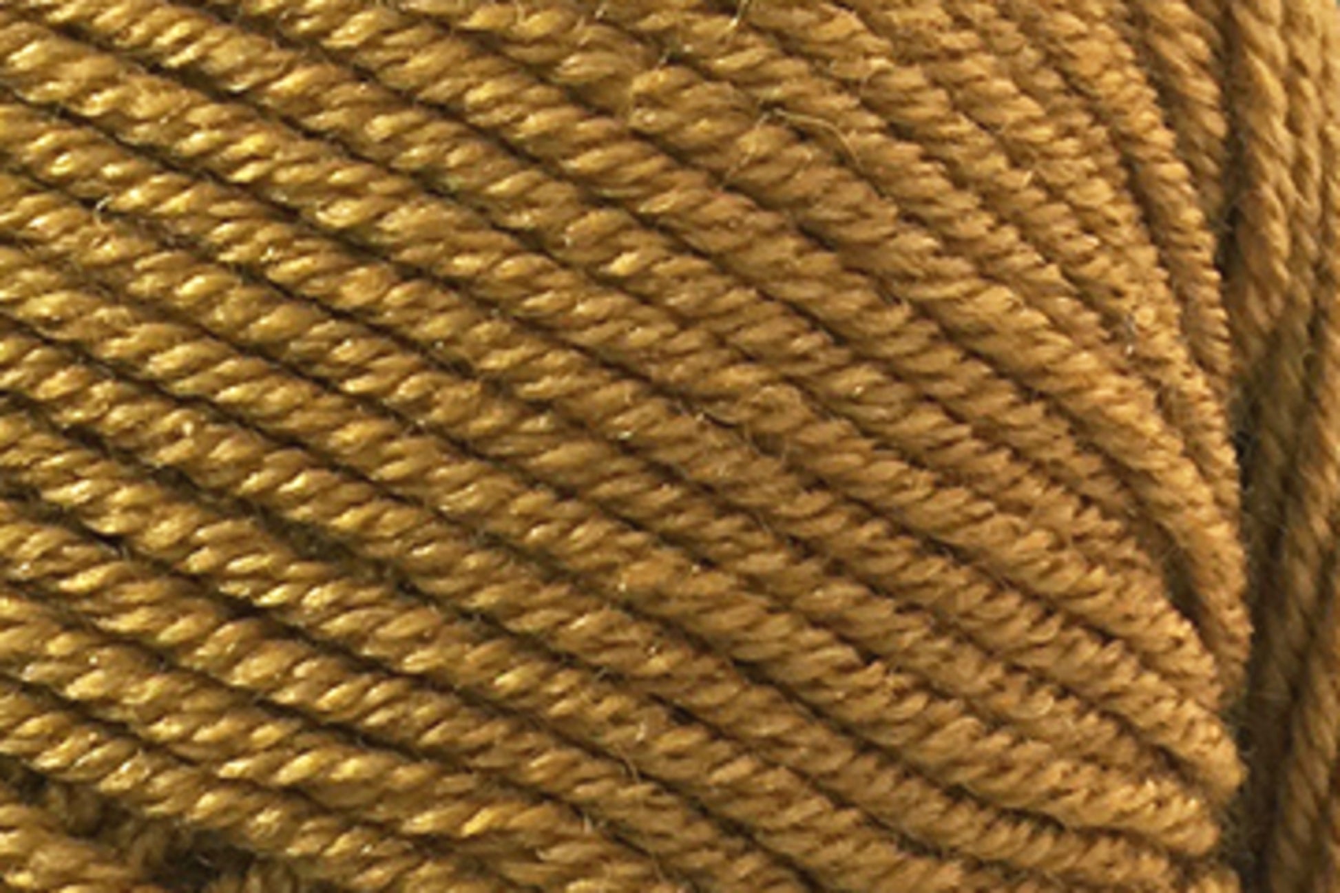 Close-up image of a ball of mustard yellow yarn, showing the texture and tightly wound strands in detail. The fibers have a slight sheen, highlighting the twisted pattern and thickness of the Jo Sharp Mulberry Silk Georgette Yarn by Kingfisher Yarn & Fibre.