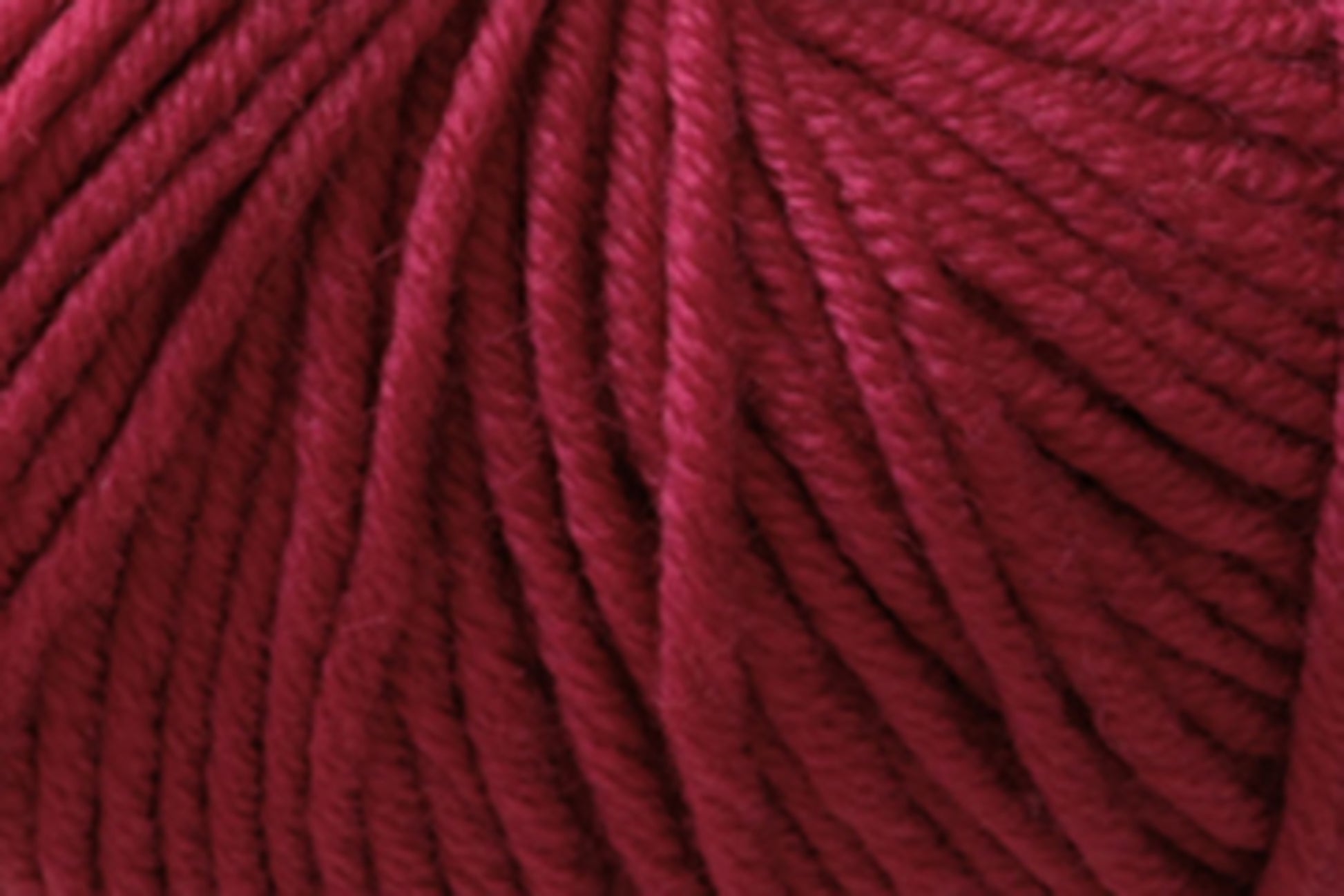 Close-up image of Jo Sharp Mulberry Silk Georgette Yarn by Kingfisher Yarn & Fibre. The yarn fibers are tightly wound, showcasing the deep burgundy hue and soft texture—ideal for crafting heirloom items that will be cherished for generations.