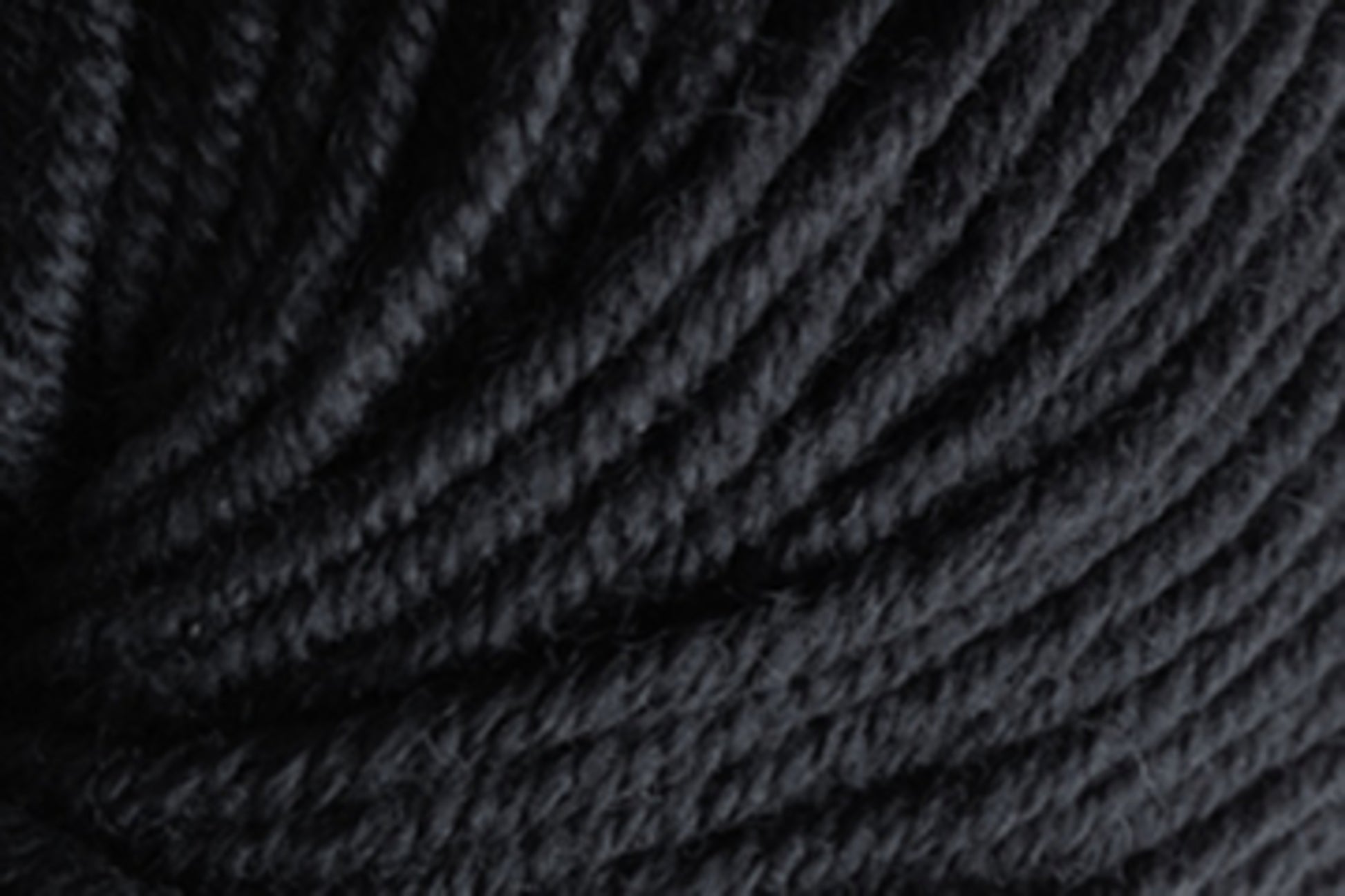 Close-up image of black Jo Sharp Mulberry Silk Georgette Yarn by Kingfisher Yarn & Fibre, showcasing its texture and tightly wound strands. The image highlights the softness and luxurious feel of the yarn, with detailed visibility of individual fibers, making it perfect for creating heirloom items.