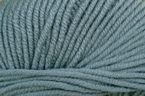 Close-up of Jo Sharp New Era Merino DK Superwash yarn in light gray-blue by Kingfisher Yarn & Fibre. The super soft fibers are tightly spun, creating a smooth and uniform texture suitable for DK weight projects like knitting or crocheting.