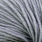 Close-up image of several strands of Jo Sharp New Era Merino DK Superwash yarn by Kingfisher Yarn & Fibre, displaying the super soft texture and details of the gray fibers—ideal for DK weight projects.