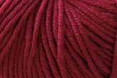 Close-up image of Jo Sharp New Era Merino DK Superwash by Kingfisher Yarn & Fibre shows deep red, machine-washable wool yarn fibers coiled together. The intricate textures and strands twist to form a thick, continuous thread that appears super soft and slightly glossy – perfect for DK weight knitting or crocheting projects.