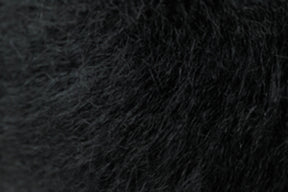 Close-up view of textured black fur, showcasing fine, dense strands and subtle variations in shading, reminiscent of the soft elegance of Kingfisher Yarn & Fibre's Jo Sharp Rare Comfort Kid Mohair.