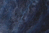 Close-up image of Jo Sharp Rare Comfort Kid Mohair by Kingfisher Yarn & Fibre, showcasing a dark blue and black textured surface. The fine, intertwined fibers create a slightly tangled appearance reminiscent of airy sweaters. The texture features a mix of light and dark shades, highlighting the material's depth and complexity.