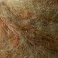 Close-up of a person's scalp with several reddish, raised marks that appear to be scars running through their light brown, slightly disheveled hair. The rugged texture contrasts sharply against the Kingfisher Yarn & Fibre's Jo Sharp Rare Comfort Kid Mohair, akin to airy sweaters delicately resting on the skin.