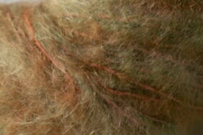 Close-up of a person's scalp with several reddish, raised marks that appear to be scars running through their light brown, slightly disheveled hair. The rugged texture contrasts sharply against the Kingfisher Yarn & Fibre's Jo Sharp Rare Comfort Kid Mohair, akin to airy sweaters delicately resting on the skin.