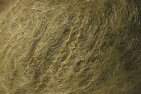 Close-up image of a soft, fuzzy, dark beige or brown wool-like texture, showcasing intertwined and slightly tangled fibers reminiscent of Jo Sharp Rare Comfort Kid Mohair by Kingfisher Yarn & Fibre used in airy sweaters.