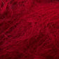 A close-up image of Jo Sharp Rare Comfort Kid Mohair by Kingfisher Yarn & Fibre, showcasing its red fibrous material with a tangled and fuzzy texture. The fibers appear soft and wispy, creating a dense and intricate pattern across the image, resembling wool or synthetic fur.