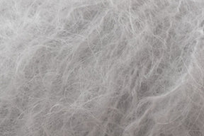 Close-up image of soft, fluffy, white and light gray fibers intertwined, resembling Jo Sharp Rare Comfort Kid Mohair by Kingfisher Yarn & Fibre. The texture of this luxurious yarn appears smooth and delicate, perfect for airy sweaters.