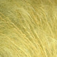 Close-up image of a field of tall, pale yellow grass or hay. The individual blades are thin and wispy, creating a textured and slightly chaotic appearance akin to Jo Sharp Rare Comfort Kid Mohair by Kingfisher Yarn & Fibre. The overall effect is a dense mat of soft, golden strands, offering rare comfort reminiscent of airy sweaters.