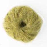 A tightly coiled bundle of Kingfisher Yarn & Fibre's Jo Sharp Rare Comfort Kid Mohair in a yellow-green hue, viewed from above. The soft, fuzzy wool roving features loose and textured fibers, perfect for felting or spinning into luxurious mohair yarn.