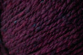 Close-up image of thick, dark burgundy Kingfisher Yarn & Fibre's Jo Sharp Silkroad Aran Tweed with subtle variations in color, displaying a textured, woven appearance. The yarn's fibers are slightly mottled, indicating a rich and soft texture that is suitable for knitting or crocheting.