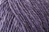 Close-up of Jo Sharp Silkroad Aran Tweed yarn by Kingfisher Yarn & Fibre, showcasing its thick, purple strands with a slightly textured appearance. The intertwined fibers appear soft and cozy, evoking a wool-like texture. This luxurious yarn features subtle variations in color and rich tweed highlights, adding depth to its overall look.