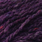 Close-up image of luxurious purple yarn with rich tweed highlights and hints of red, showcasing its texture and fibers. The Kingfisher Yarn & Fibre Jo Sharp Silkroad Aran Tweed appears thick and slightly fuzzy, with visible strands twisted together.