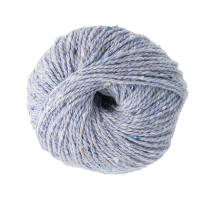 An opulent ball of light gray Jo Sharp Silkroad Aran Tweed yarn by Kingfisher Yarn & Fibre, adorned with specks of blue and tan on a pristine white background.