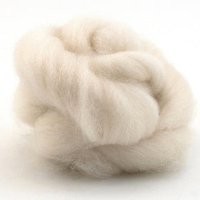 The Punta Wool Top Fiber from Jagger Brothers, Inc. is a fluffy, off-white ball of Chilean wool roving. The loose fibers are soft and voluminous, with a gentle, slightly twisted appearance perfect for spinning. The plain white background highlights the texture and color of the wool beautifully.