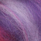 Close-up of the Multi-Colored Merino Wool Top by Europa Wools Ltd, featuring textured fibers in vibrant shades of purple, pink, and white that create a soft and fluffy heathered appearance.