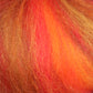 Close-up of vibrant fiber strands in shades of orange, red, and yellow that bring to mind the Multi-Colored Merino Wool Top from Europa Wools Ltd. The warm, fiery pattern appears soft and fluffy, similar to genuine merino wool.