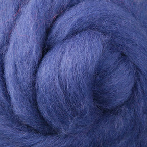 A detailed view of Ashford Handicrafts Limited’s Corriedale New Zealand Wool Fiber to Spin and Felt reveals a tightly wound coil of soft, deep blue fibers. The texture is fluffy and luxuriant, making it perfect for spinning or felting, showcasing the richness of the material.