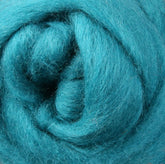 A close-up view of Ashford Handicrafts Limited's Corriedale New Zealand Wool Fiber to Spin and Felt, reveals tightly wound teal fibers that highlight a soft and fluffy texture. The densely packed fibers form a swirl pattern, accentuating the wool's vibrant color.