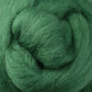 Close-up of the soft, green fibers of Ashford Handicrafts Limited's Corriedale New Zealand Wool Fiber to Spin and Felt, compactly swirled together in a textured coil. Its fine strands create a fluffy appearance, highlighting the rich green hue.