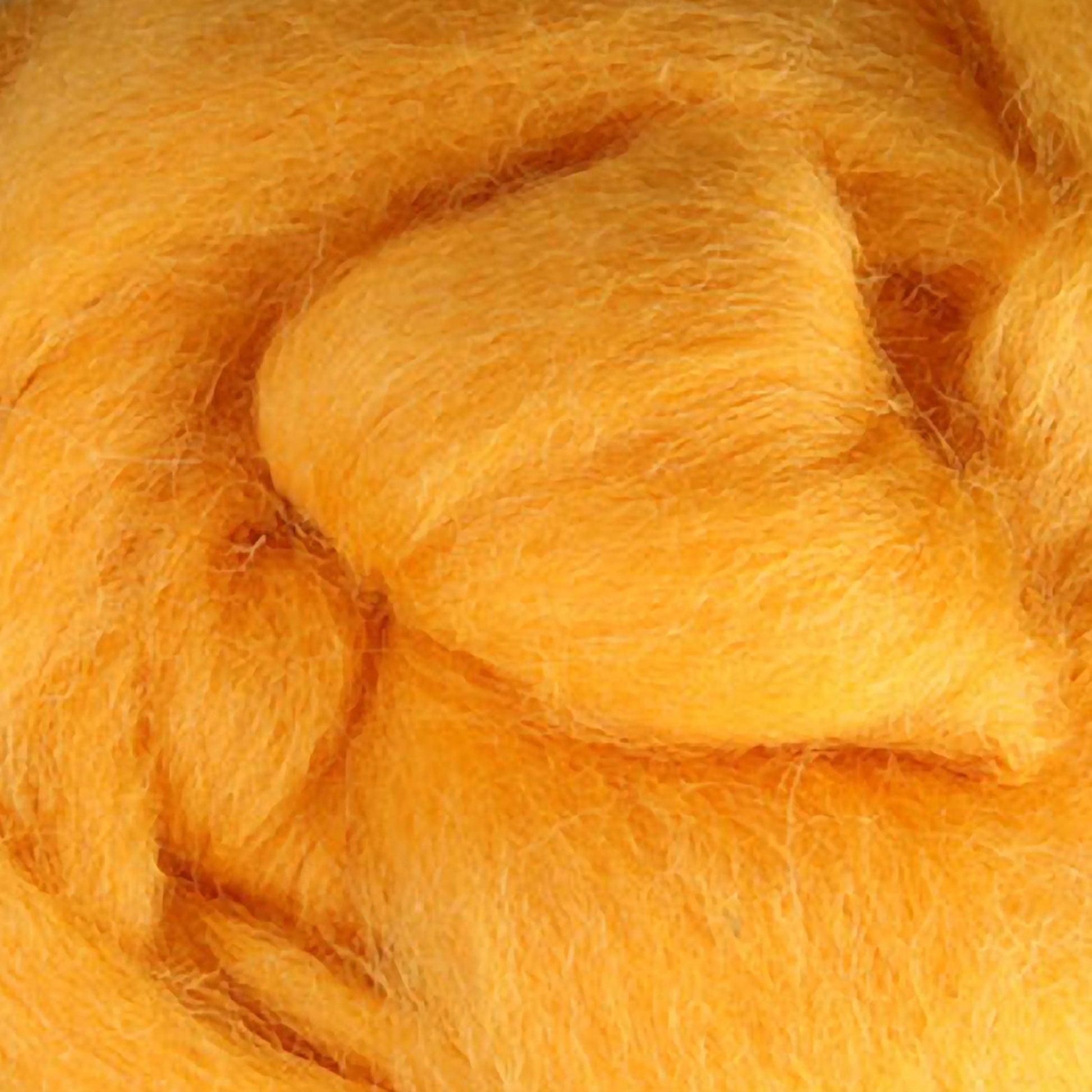 A close-up of the soft, fluffy Corriedale New Zealand Wool Fiber to Spin and Felt from Ashford Handicrafts Limited reveals tightly bundled yellow fibers. The strands have a smooth, textured appearance that highlights their natural quality. The warm color is vibrant and evenly distributed throughout the fibers.