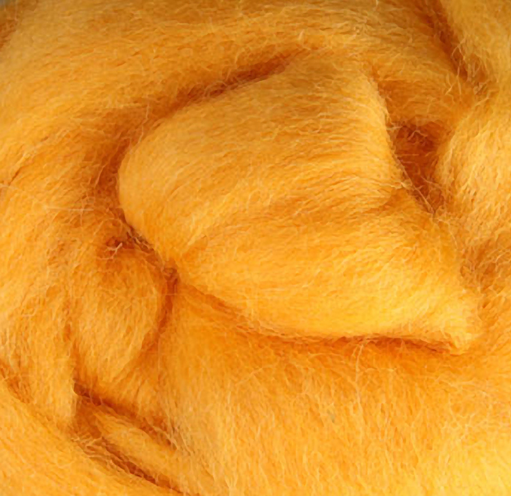 A close-up view reveals the soft, fluffy yellow wool fibers of Ashford Handicrafts Limited's Corriedale New Zealand Wool Fiber to Spin and Felt, tightly packed to highlight their smooth texture and vibrant color. This exquisite felting wool could easily be mistaken for premium quality fiber.