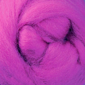 Close-up of vibrant pink wool roving from Ashford Handicrafts Limited, tightly coiled and forming soft, fluffy layers. The texture appears smooth and fibrous, ideal for crafting or felting projects with Corriedale New Zealand Wool Fiber to Spin and Felt (sold by the ounce).