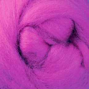 A close-up of bright pink New Zealand Corriedale wool fiber from Ashford Handicrafts Limited, tightly wound into a circular shape. The soft, fibrous texture showcases vibrant magenta hues—perfect for spinning and felting enthusiasts using this premium wool sold by the ounce.