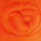 Close-up of soft, vibrant orange Corriedale New Zealand Wool Fiber from Ashford Handicrafts Limited, sold by the ounce, intricately rolled into a circular shape for a textured and cozy appearance.