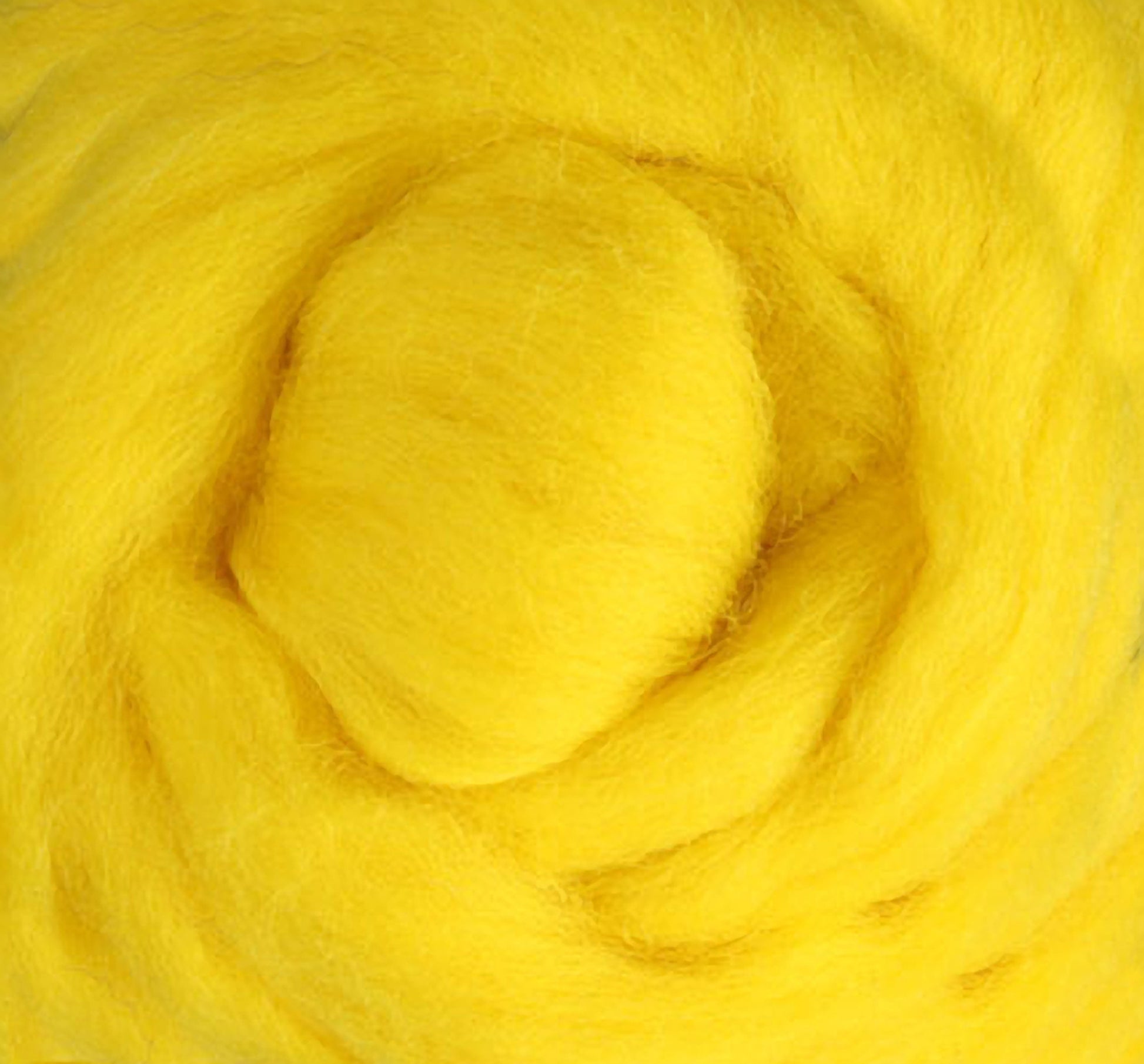 The Corriedale New Zealand Wool Fiber to Spin and Felt by Ashford Handicrafts Limited, available in bright yellow by the ounce, is coiled in a circular pattern and offers a soft, fluffy texture ideal for wool felting projects. Its closely packed fibers create a vibrant, colorful display.