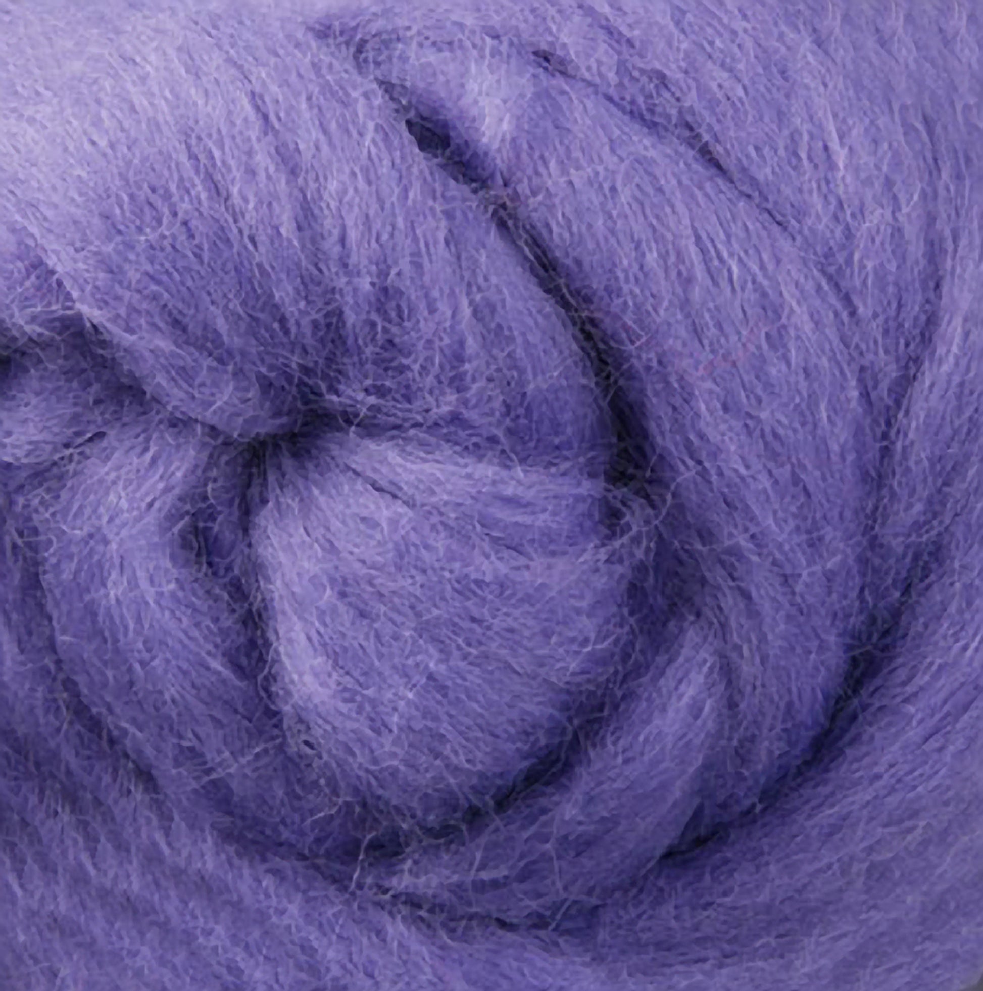 Close-up of soft, fluffy Corriedale New Zealand wool fiber, twisted in a circular pattern. This texture highlights the fibrous quality of Ashford Handicrafts Limited's wool, creating a cozy and inviting appearance that is perfect for spinning and felting enthusiasts.