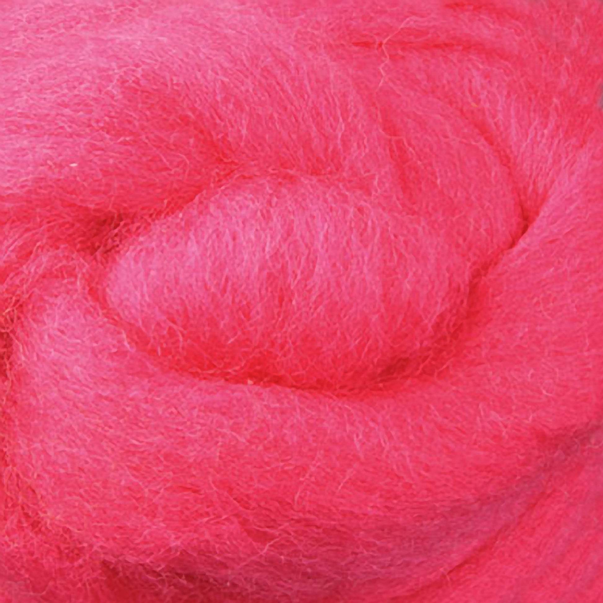 A close-up of a bundle of Corriedale New Zealand wool fiber by Ashford Handicrafts Limited, sold by the ounce, reveals its fluffy and soft texture. The vibrant pink fibers are lightly coiled, creating a textured appearance ideal for spinning and felting projects.