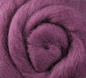 Close-up of a spiral-shaped texture featuring the Corriedale New Zealand Wool Fiber to Spin and Felt, sold by the ounce. This luxurious product from Ashford Handicrafts Limited showcases soft and fluffy purple fibers intertwined in a circular pattern, highlighting its gentle touch and vibrant appearance.