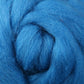 Close-up of a textured, fluffy spiral made from "Corriedale New Zealand Wool Fiber to Spin and Felt," by Ashford Handicrafts Limited, highlighting its soft and thick strands.