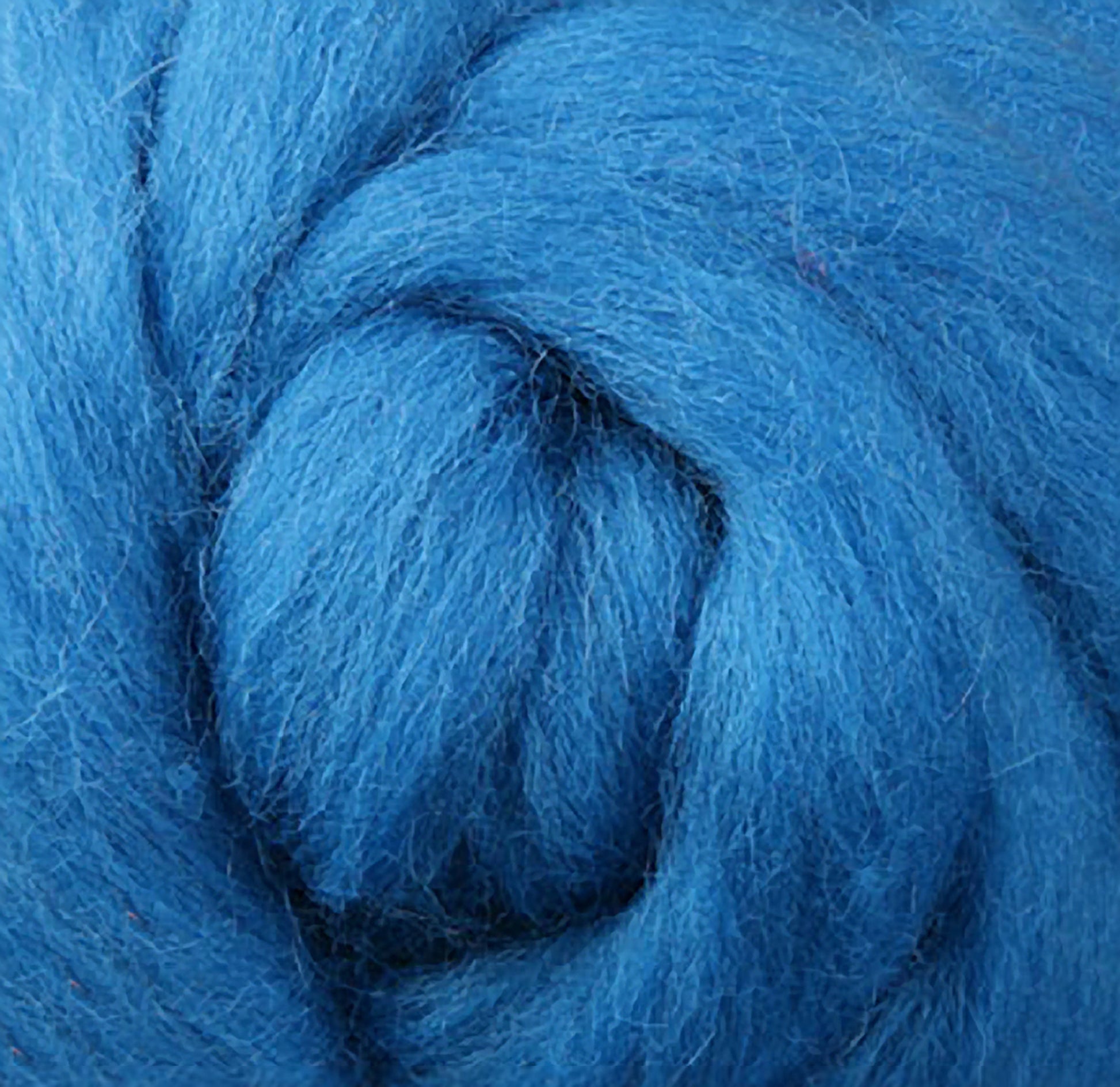 Close-up of a textured, fluffy spiral made from "Corriedale New Zealand Wool Fiber to Spin and Felt," by Ashford Handicrafts Limited, highlighting its soft and thick strands.