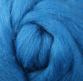 Close-up of a textured, fluffy spiral made from "Corriedale New Zealand Wool Fiber to Spin and Felt," by Ashford Handicrafts Limited, highlighting its soft and thick strands.